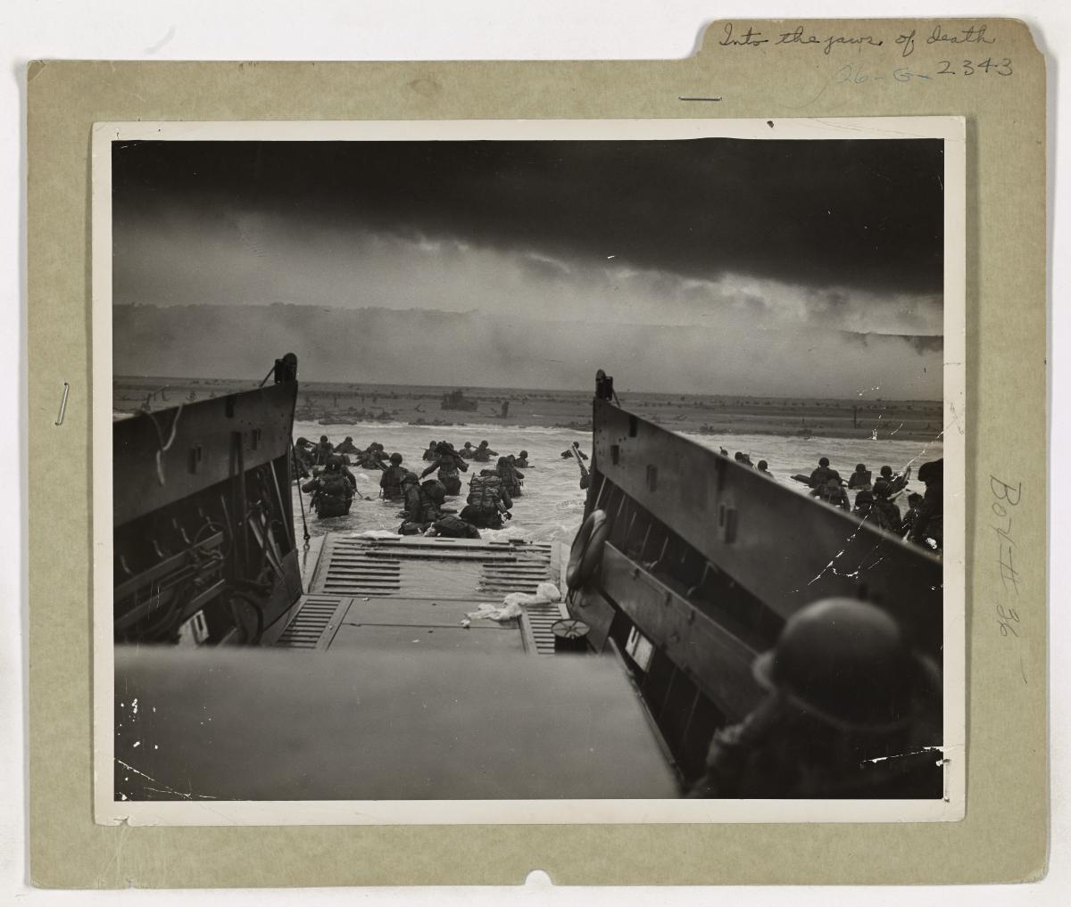 U.S. troops leaving a landing craft and wading toward Omaha Beach on D-Day
